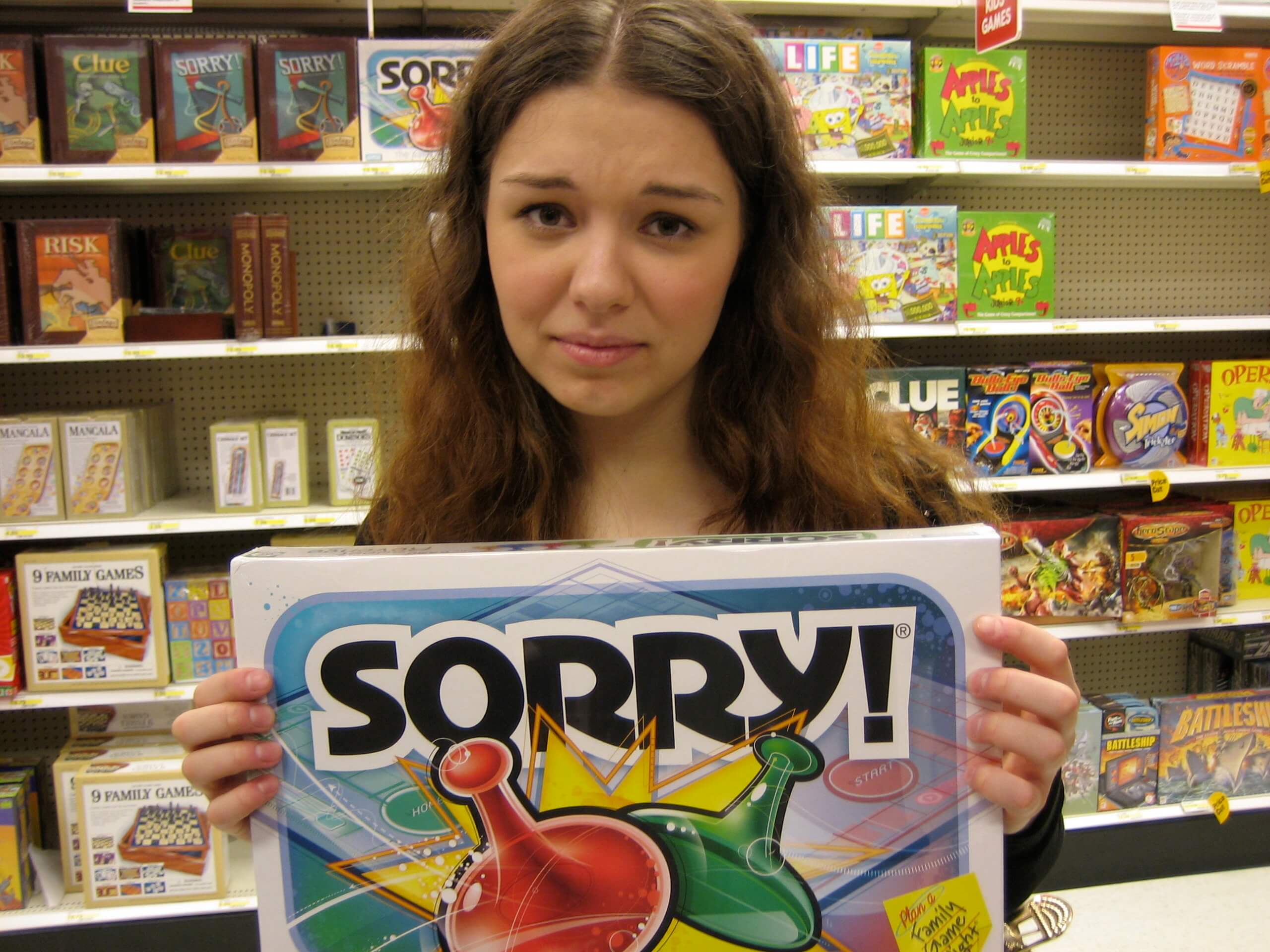 Woman-looking-at-camera-holding-Sorry-boardgame